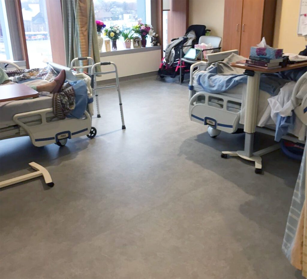 Hospital beds sitting on top of SmartCells flooring in senior living center