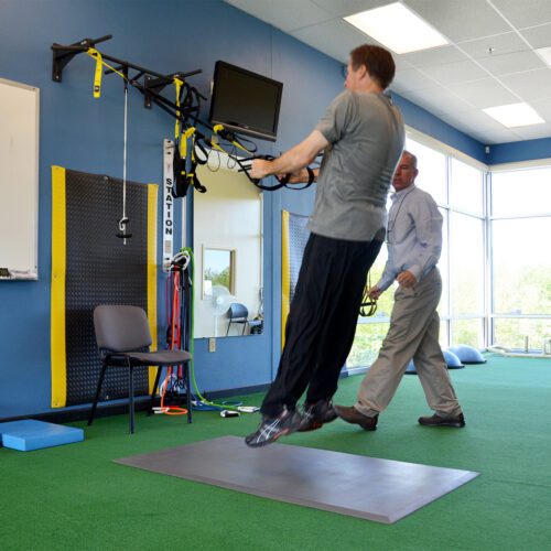 Patient doing rehab exercises in physical therapy clinic