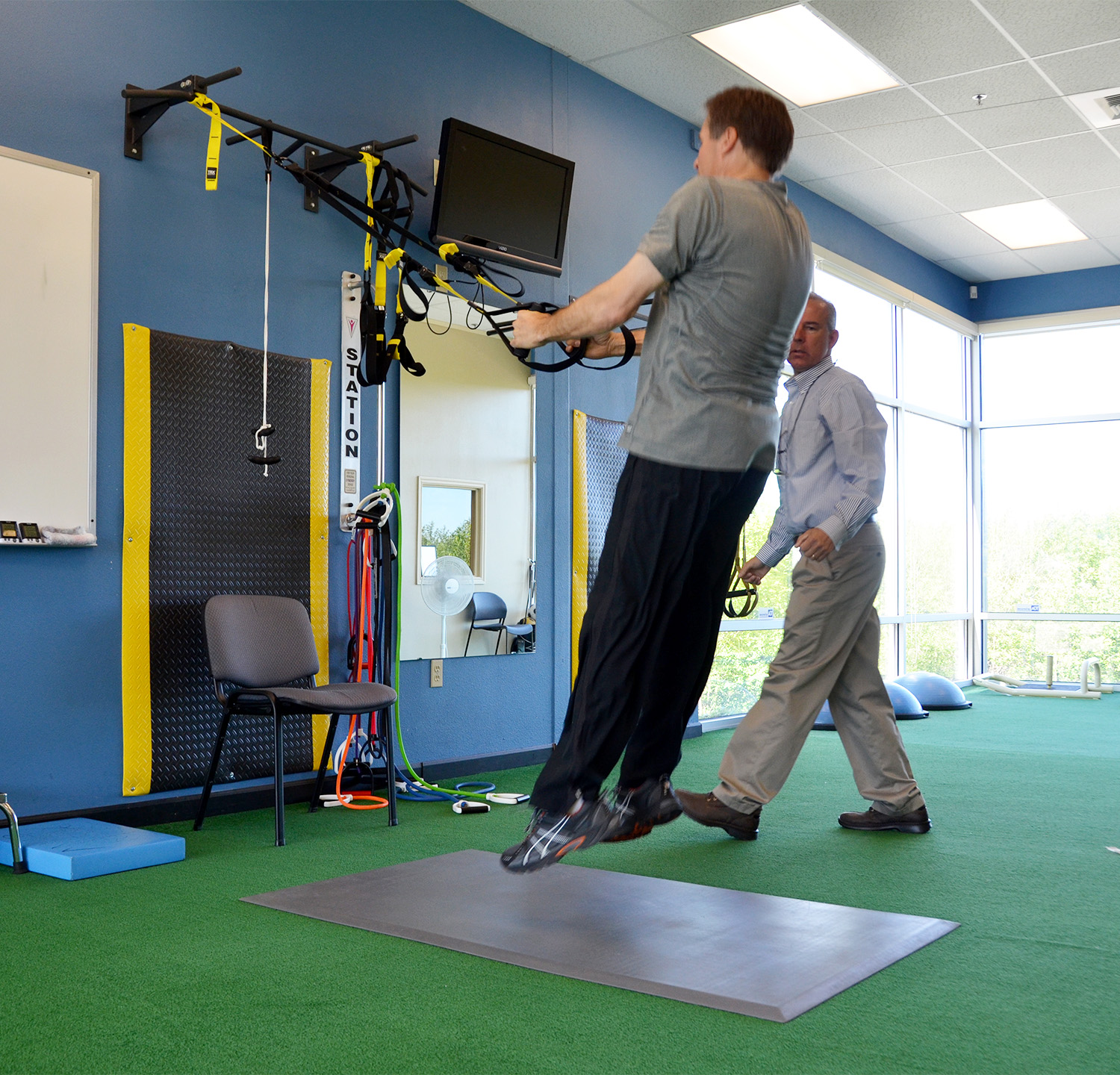 Patient doing rehab exercises in physical therapy clinic