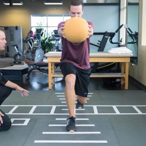 Patient doing rehab exercises on SmartCells physical therapy mat