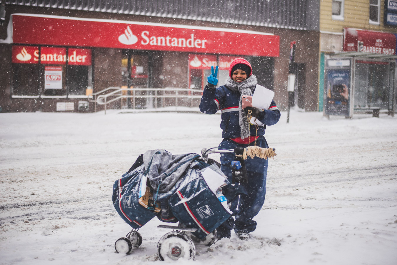 Postal service employee delivering mail in snow