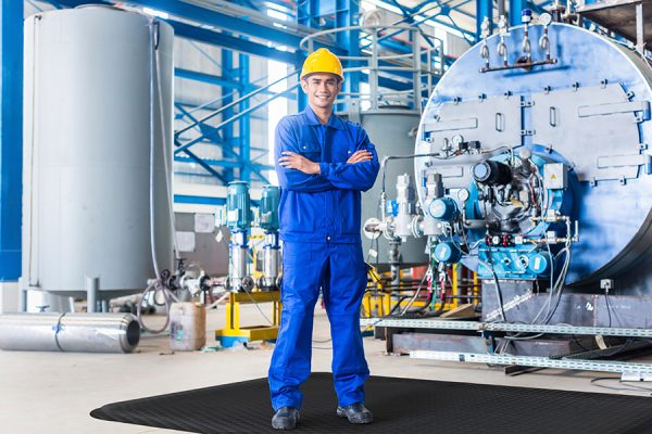 Hog-Heaven-in-use-industrial-black-border-website Employee standing on mat in industrial environment