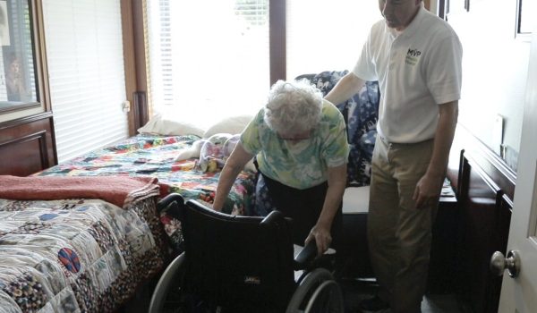 SmartCells Fall Protection customer women getting into wheel chair in residential environment