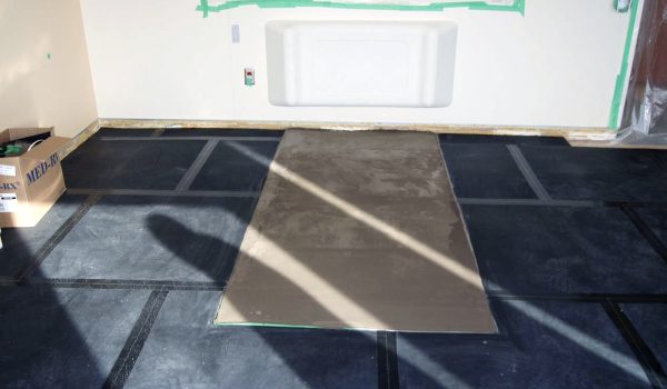 SmartCells Fall Protection flooring installation SmartCells tiles being installed as an underlayment in a medical facility