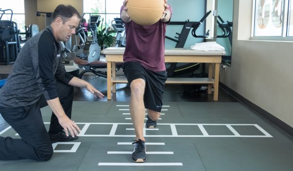 Patient doing rehab exercises on the Smartcells Physical Therapy mat