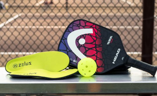 Zelus Insoles Pickleball Zelus Insoles sitting next to pickleball paddle and ball